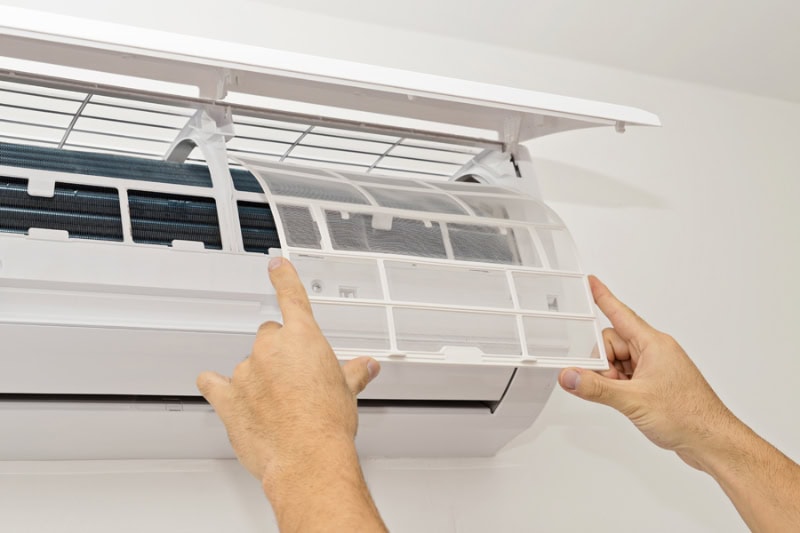 Changing the filter in the air conditioner. The concept of safe and healthy housing.