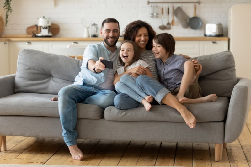 Family of four enjoying the comfort of their home.